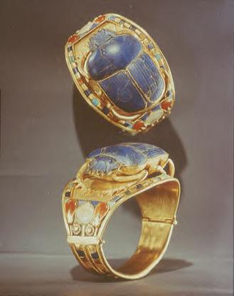 One of Tutankhamun's many bracelets found in his tomb, shown two ways.  The setting is gold, topped by a scarab beetle made of lapis lazuli and accented with various stones like carnelian, turquoise, and amazonite (feldspar).